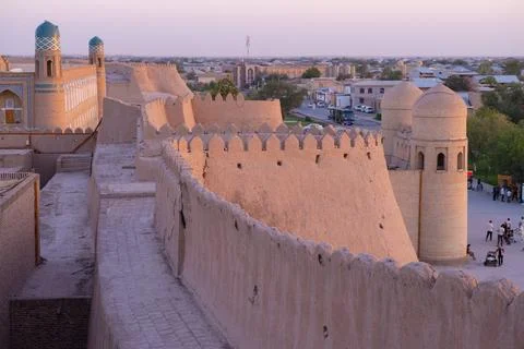 The wall of the ancient city of Ichan-Kala in the rays of the rising sun. Stock Photos