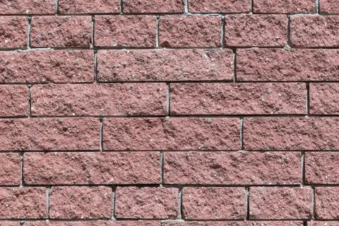 The wall and the bricks are red or brown. Stock Photos