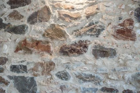 The wall background is made of stone, highlighted from above. Stock Photos