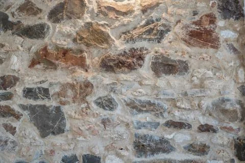 The wall background is made of stone, highlighted from above. Stock Photos