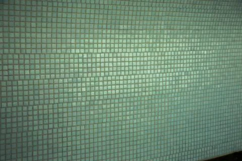 Wall background with an old ruined ceramic Venetian mosaic. Background of a w Stock Photos