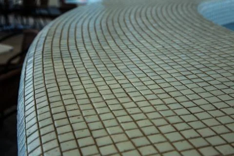 Wall background with an old ruined ceramic Venetian mosaic. Background of a w Stock Photos