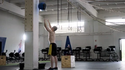 Wall ball exercise - young man doing functional workout at the gym Stock Footage 65280140