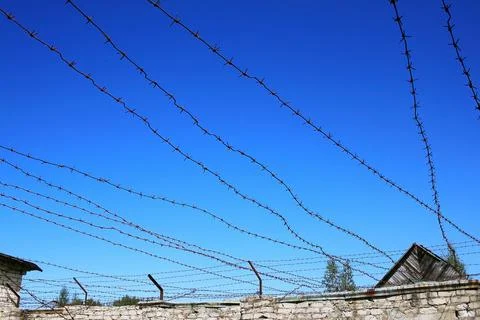 Wall with barbed wire Stock Photos