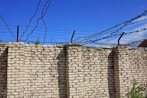 Wall with barbed wire Stock Photos