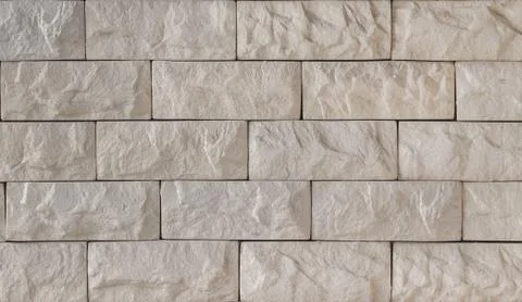 Wall of beige decorative brick Stock Photos