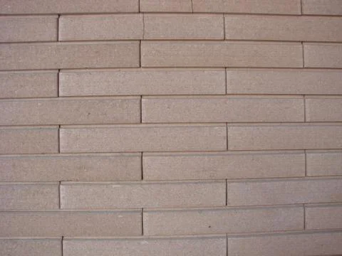 Wall from beige oblong bricks, background, texture Stock Photos