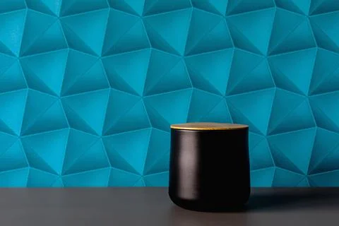 A wall with blue patterned wallpaper. Black containers for storing sugar, t.. Stock Photos