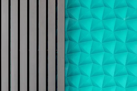 A wall with blue patterned wallpaper. A modern gray radiator. Background in.. Stock Photos