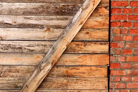 A wall of boards and bricks. Stock Photos