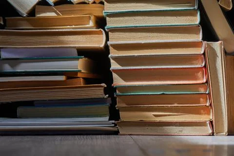 Wall of books piled up Stock Photos