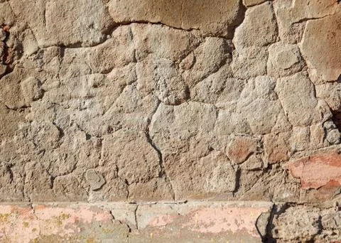 A wall with a brick border and a large crack in it Stock Photos
