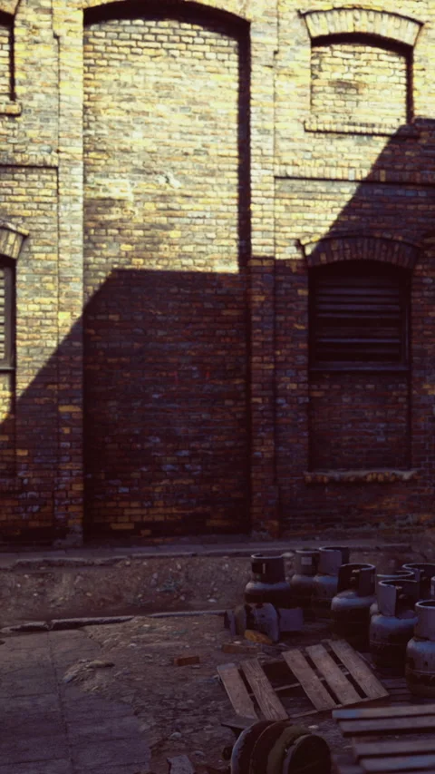 Wall of brick building with shadow from window in late afternoon light Stock Footage 334191151