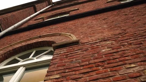 Wall of a brick house in Germany with large white windows Stock Footage 246399708