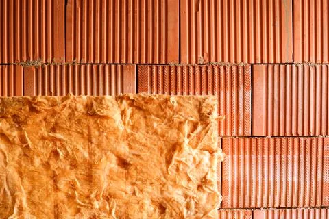 Wall of bricks and insulation wool. Building with cavity wall insulation. Clo Stock Photos
