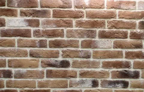 Wall with brickwork under the old destroyed brick of light beige. Stock Photos