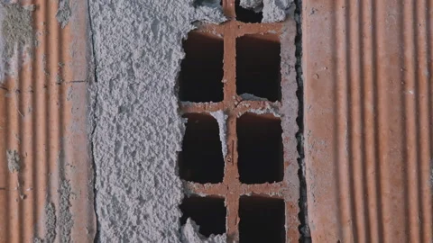 Wall of broken red bricks in grey concrete. Close-up shot, construction concept Video stock 258736616