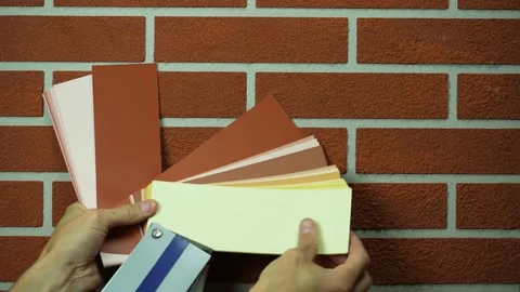 A wall with a brown brick-type decorative plaster, brown shades to match Stock Footage 220682130