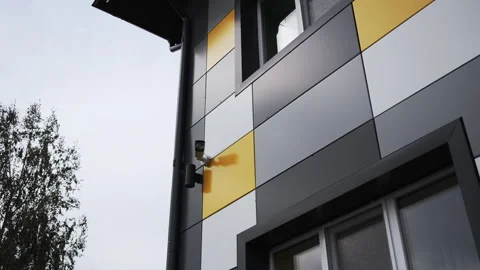 Wall of building finished in brightly colored tiles with CCTV Stock Footage 295663548