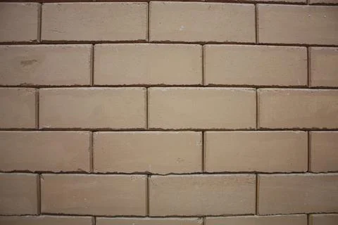 A wall of a building made from interlocked bricks 스톡 사진