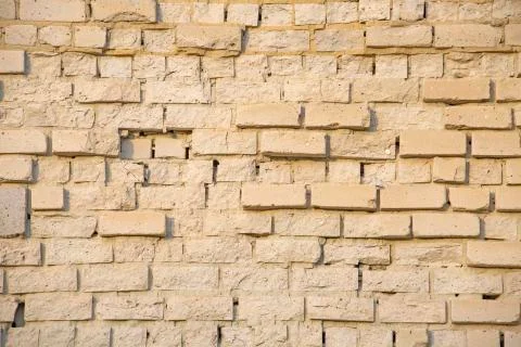 The wall of the building is made of old white brick. Background for text Stock Photos