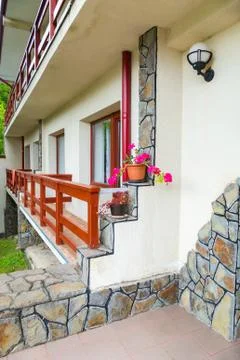 The wall of the building with railing around the windows and a three-tiered c Fotos de archivo