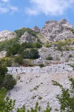 Wall built with marble blocks in a quarry in the Apuan Alps in Tuscany. Stock Photos