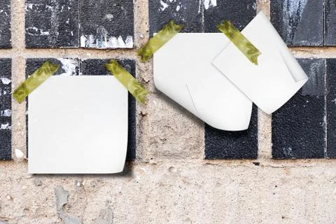 Wall with a ceramic tile and notes paper Stock Photos