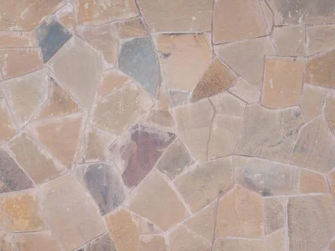 Wall with cladding of chaotically well-built fragments of tiles of different Fotos Stock