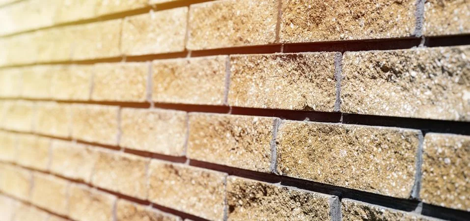 Wall cladding. Decorative bricks with rocky relief surface. Wide-angle Fotos Stock