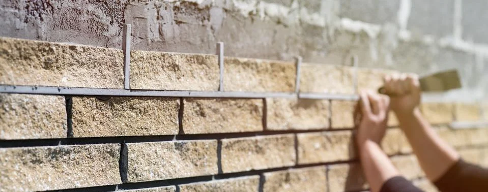 Wall cladding. Decorative bricks with rocky relief surface. Wide-angle Fotos Stock