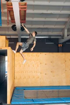Wall climbing activity. acrobatic movement. full length side view photo Stock Photos