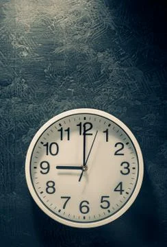 Wall clock at abstract black background Stock Photos