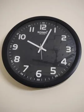 Wall clock on a black background Stock Photos