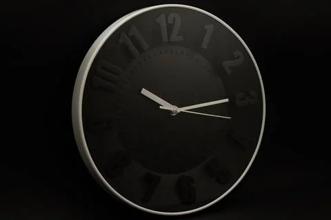 Wall clock on black background, subject photography Stock Photos