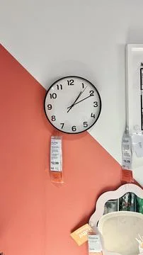 Wall clock displayed in IKEA shopping centre with modern design, featuring black Stock Photos