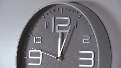 Wall clock on a gray background. 00:05 Stock Footage 124364170
