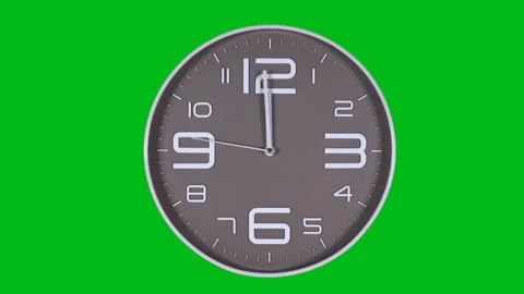 Wall clock on a green background 库存影片 121966154