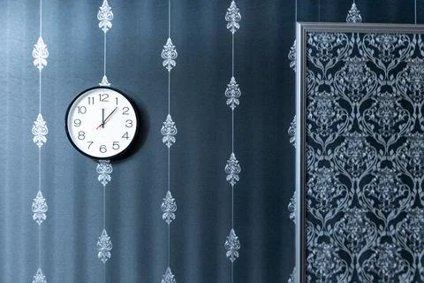 A wall clock with the hands on the number 3 and 9 Stock Photos