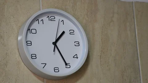 Wall clock indicating the time with its hands Stock Footage 300825677