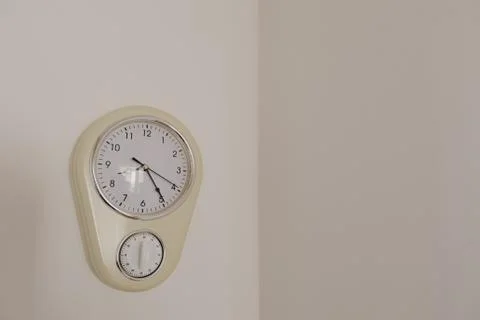 Wall clock with manual timer hanging on the wall - Image Stock Photos