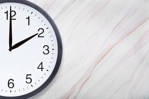 Wall clock on marble texture with natural pattern with copyspace Stock Photos