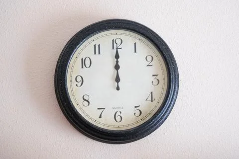 Wall clock marking twelve o'clock on the new year Foto stock