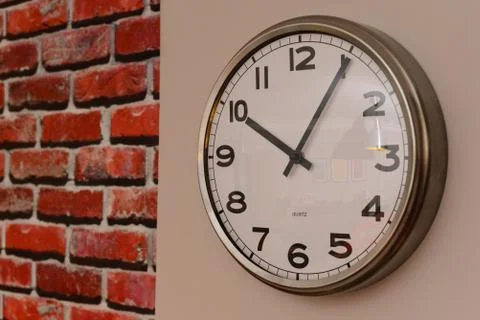 Wall clock with modern dials close up view Stock Photos