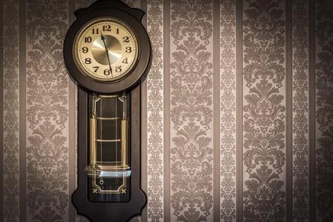 Wall clock with pendulum Stock Photos