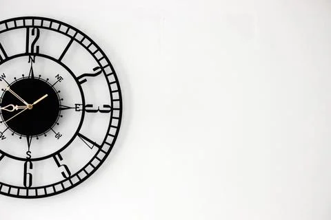 Wall clock placed in the left side of the background to create a black and white Foto stock