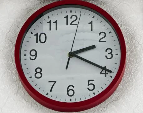 Wall clock round red white plastic. Stock Photos