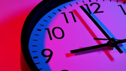 Wall clock show running time. Time lapse. Clock face on blue and red background. Stock Footage 295438300