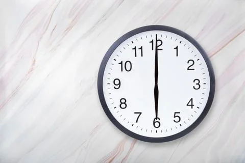 Wall clock show six o'clock on marble texture. Office clock show 6pm or 6am Stock Photos