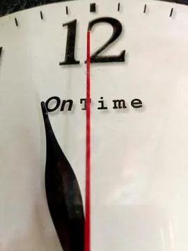 The wall clock shows the time. Stock Photos